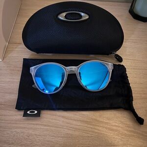 Oakley Clear Frame Sunglasses with Blue Lenses
